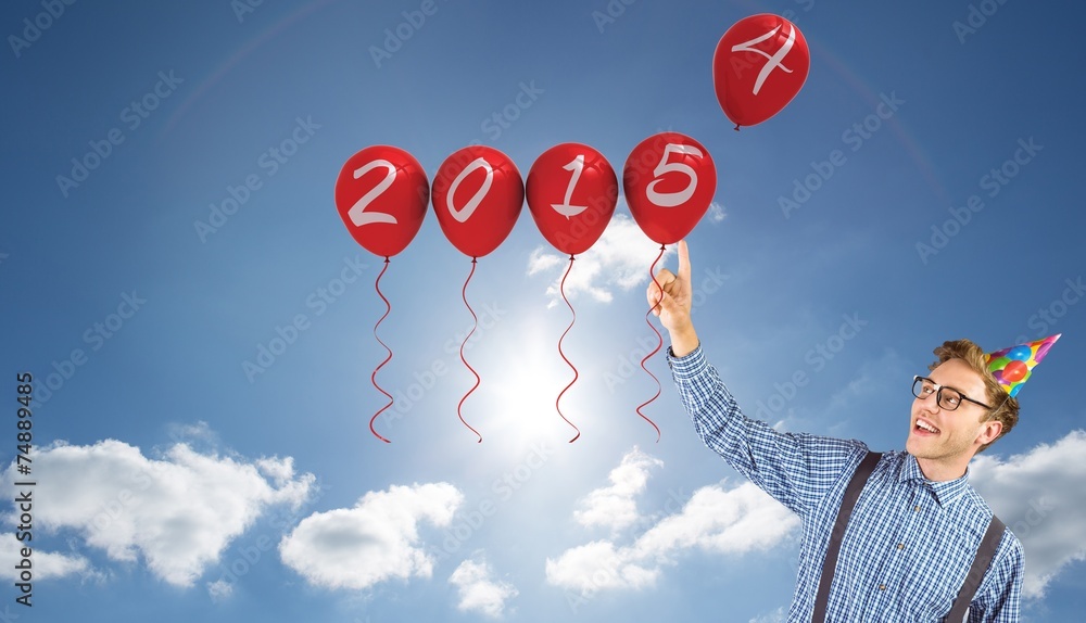 Poster Composite image of geeky hipster wearing party hat pointing