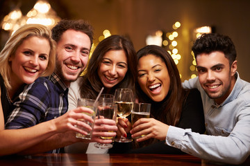 Group Of Friends Enjoying Evening Drinks In Bar
