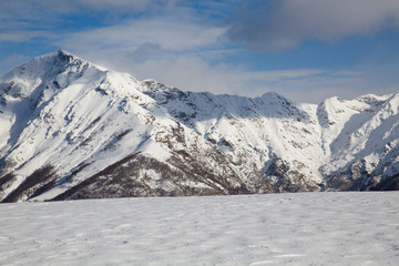 snowy mountains with clouds