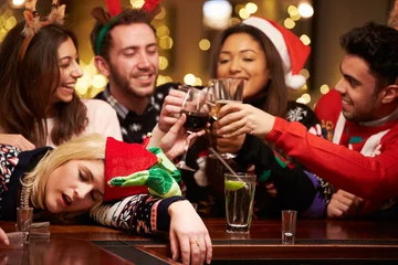 Papier Peint photo Bar Woman Passed Out On Bar During Christmas Drinks With Friends