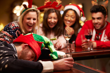 Man Passed Out On Bar During Christmas Drinks With Friends