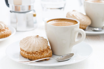 cup of espresso and cakes for breakfast on table