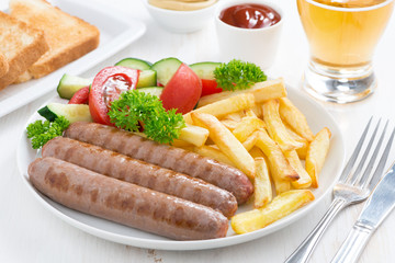 grilled sausages with French fries and vegetables