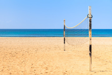Obraz na płótnie Canvas Beach Volleyball on sandy beach with sea and blue sky in the bac