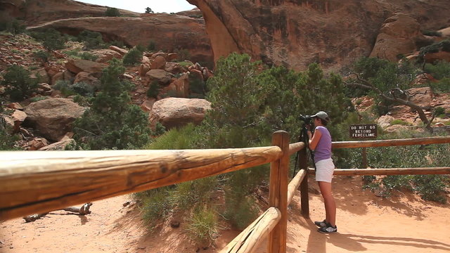 Tourist photographing in Arches National Park, Utah, USA