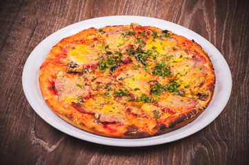 pizza with ham on white plate