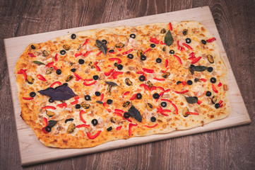 super big pizza on wooden plate