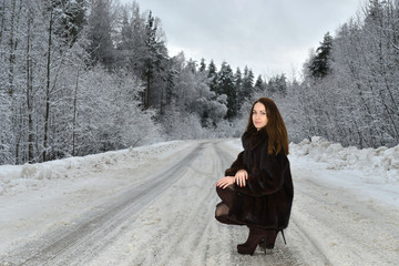 One beautiful girl in winter forest