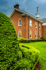 Storm clouds over bushes and a building at the Lutheran Seminary - obrazy, fototapety, plakaty