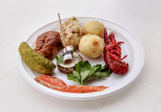 Still life of food on a white plastic plate