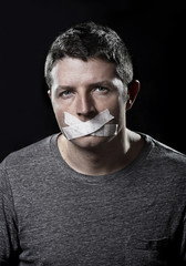 attractive man mouth shut on tape freedom of speech concept