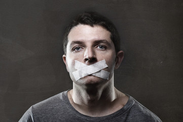 attractive man mouth sealed on tape freedom of speech concept