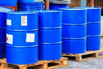 Big blue barrels on wooden pallets