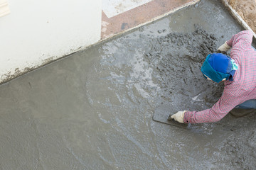 plasterer concrete cement worker plastering flooring of house