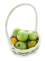 basket of green apples on white background
