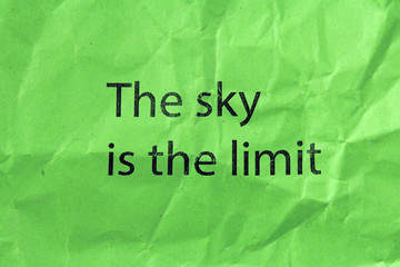 the sky is the limit text on green paper