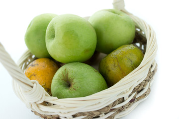 basket of green apples on white background