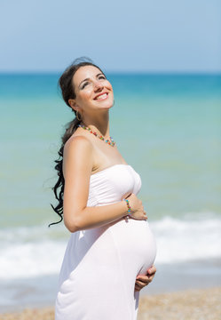 Expectant mother on the beach