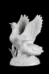 porcelain figurine duck on a black background