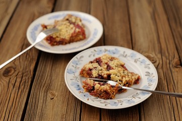 Plum crumble on wooden background