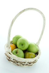 basket of green apples on white background