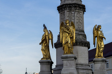 Three golden angels statues in front of the Cathedral