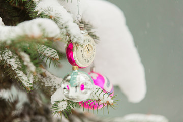 New Year's toys on a snow-covered Christmas tree