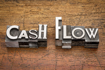 cash flow in metal type - obrazy, fototapety, plakaty