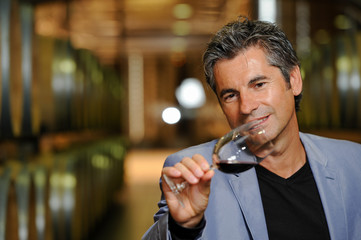 Tourism - Man tasting wine in a cellar-Winemaker