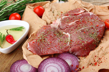 Raw beef steak on wooden table