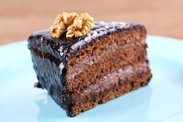 Delicious chocolate cake on plate on table close-up