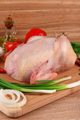 Raw chicken on wooden table