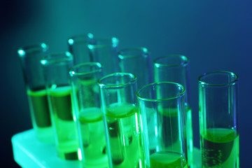 Green fluid in test-tubes on the dark background