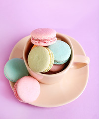Assortment of gentle colorful macaroons in colorful mug