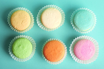Set of gentle colorful macaroons on color background