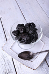 Glass bowl of prunes