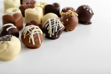 Delicious chocolate candies isolated on white
