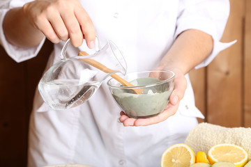 Beautician makes cosmetic facial masks, close-up,