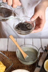 Beautician makes cosmetic facial masks, close-up,