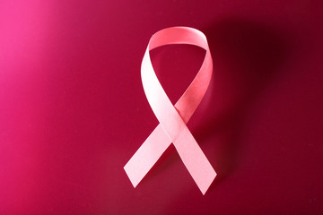 Pink breast cancer ribbon on pink background