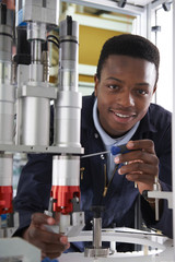 Engineer Working On Machine In Factory