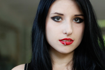 Fototapeta premium Portrait of girl with black hair and red lipstick