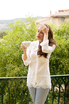 Portrait of young woman with headache