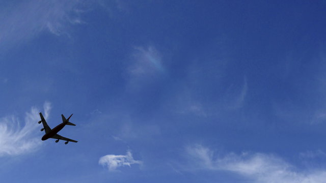 airplane flying overhead silhouetted plane