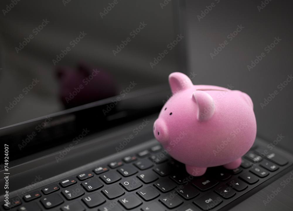 Wall mural piggy bank on laptop