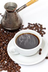 Coffee cup and beans on a white background.