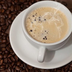 Coffee cup and beans. Selective focus.