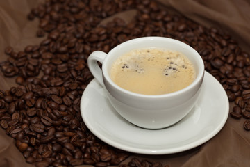 Coffee cup and beans. Selective focus.