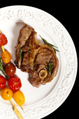 Lamb Chops with cherry tomato. Selective focus.