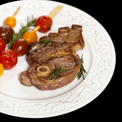 Lamb Chops with cherry tomato. Selective focus.